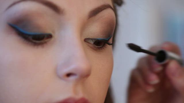 Eyes of a woman getting makeup .