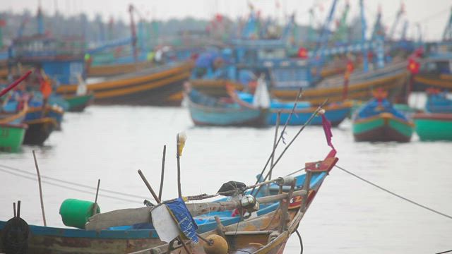 Parked fisher boats moving with the tide.