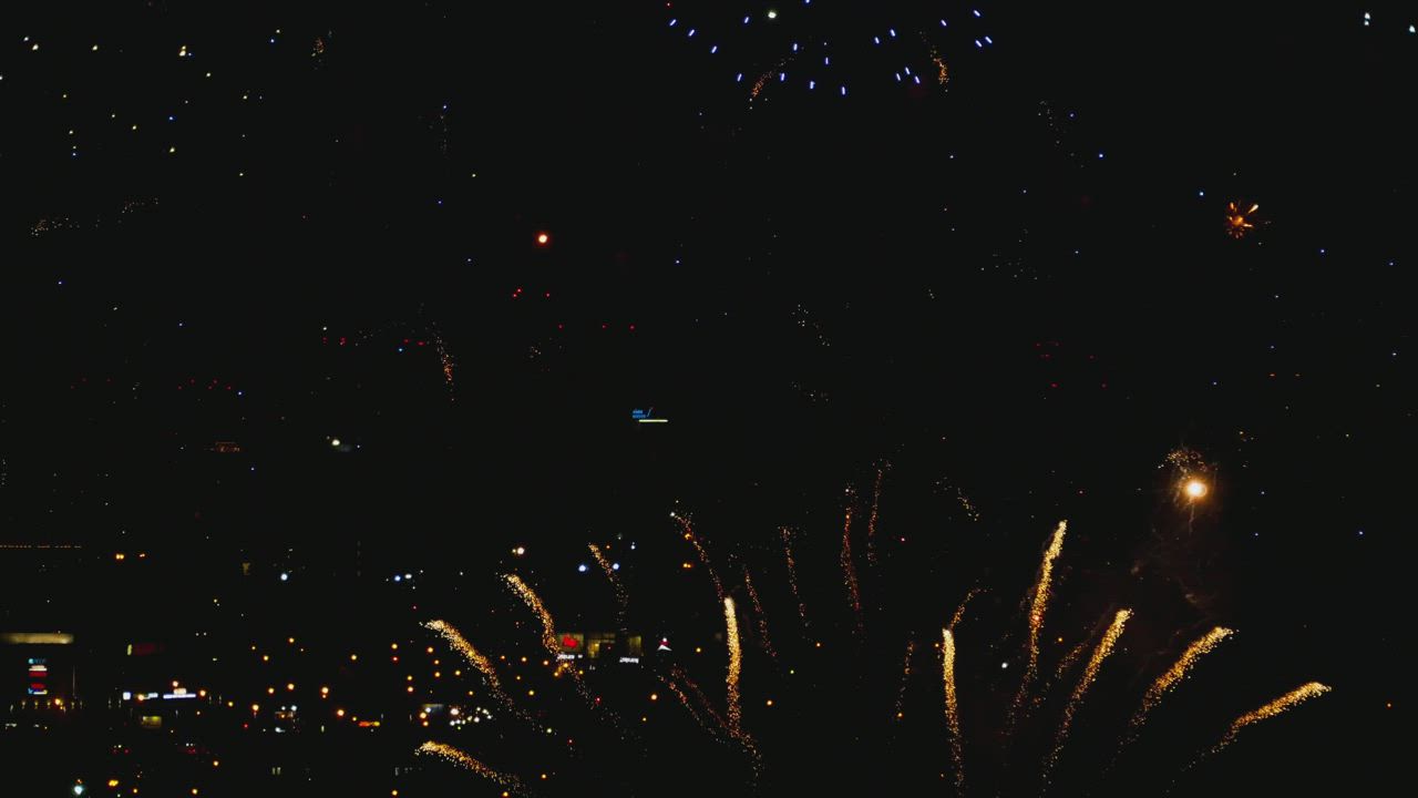 Fireworks illuminate the sky with a colorful explosion - Free Stock Video