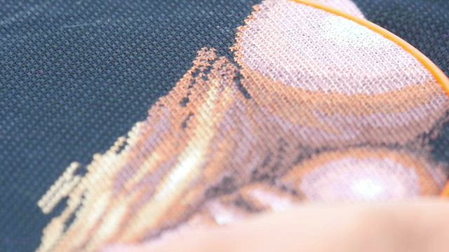 Woman working on embroidery .