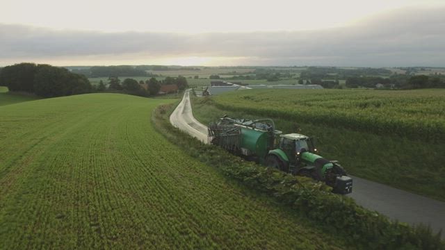 Tractor driving on a country road.