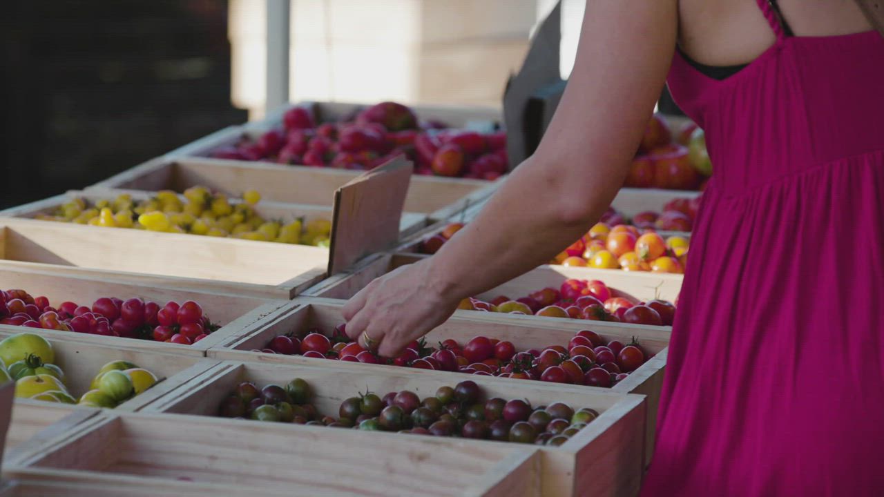 A woman choosing fruit at a market - Free Stock Video