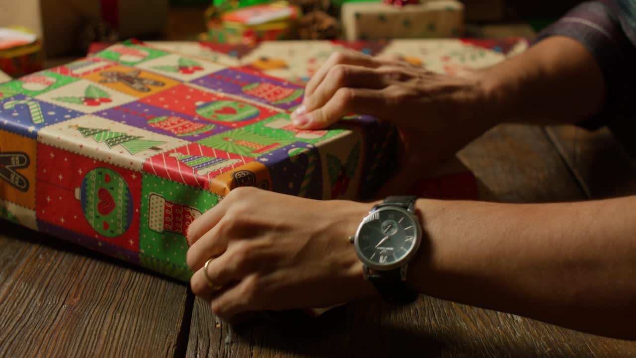 Hands Finishing A Christmas Present Wrap.
