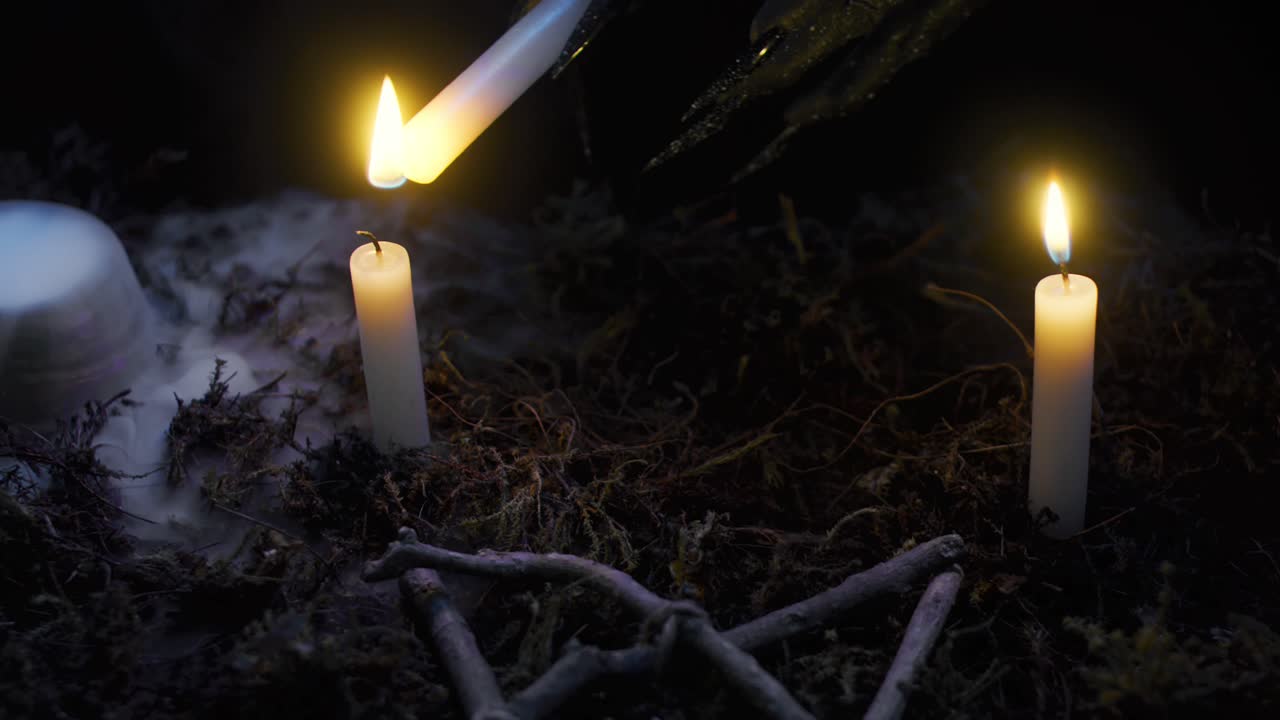 Eerie Hand Lighting Witchcraft Candles.